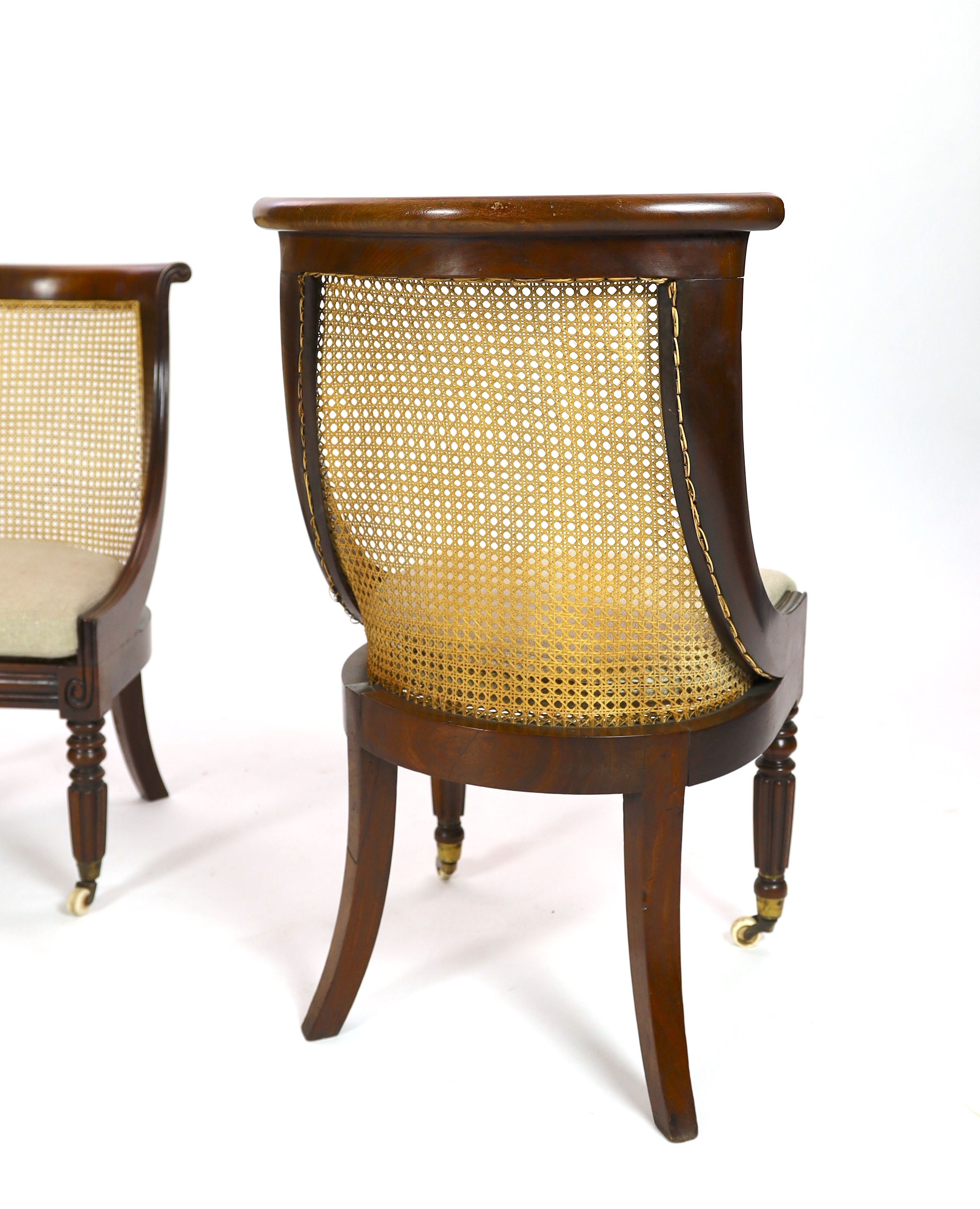 A pair of late Regency mahogany bergere side chairs